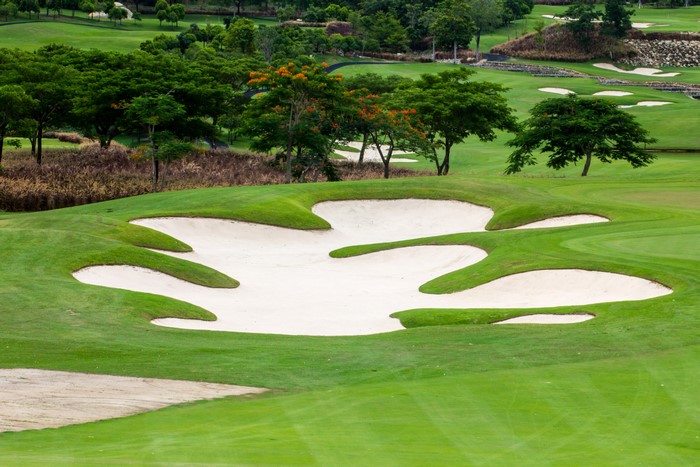 Golf course with sand traps and trees