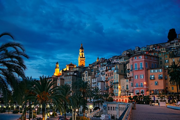 Menton, France at dusk with palm trees