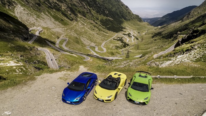 Three Lamborghinis on a winding mountain road