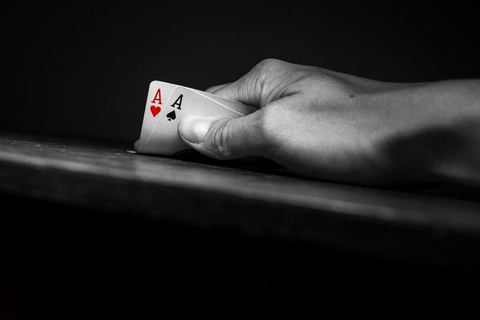 Two Aces Poker Cards Held by Hand