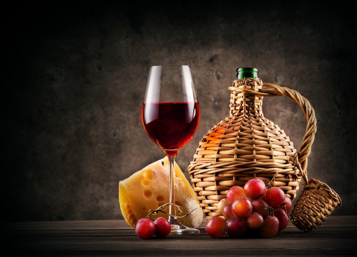 Still-life with wine, grapes, cheese, and bottle