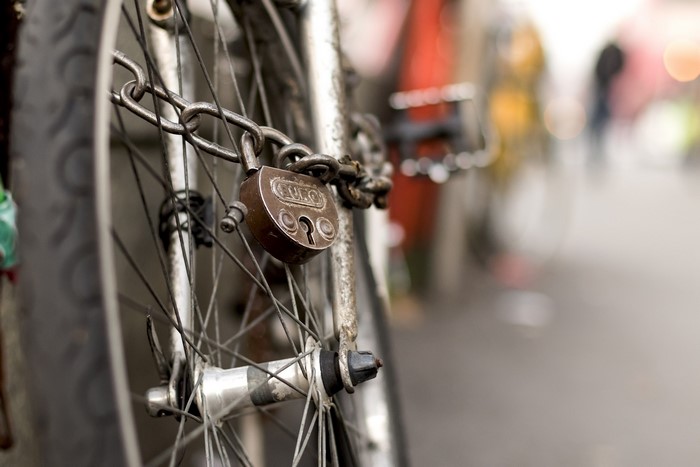 Bicycle wheel locked with a padlock and chain