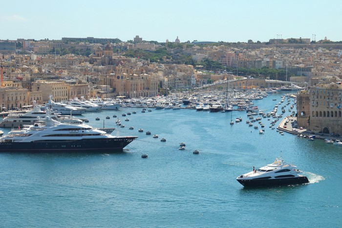 Yachts docked in a bay with Valetta, Malta in the background