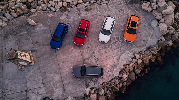 Audi RS2 and RS4 Avant cars parked on a rocky shore