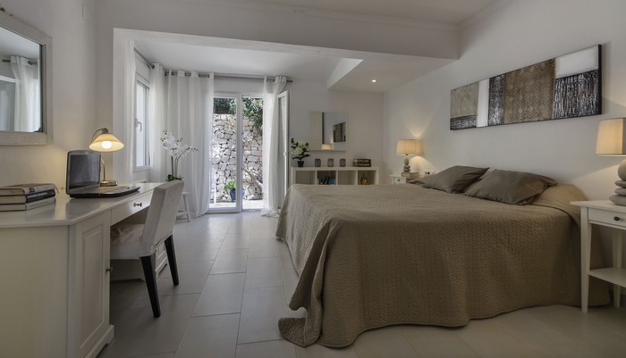 Bedroom with desk, bed, and outdoor access