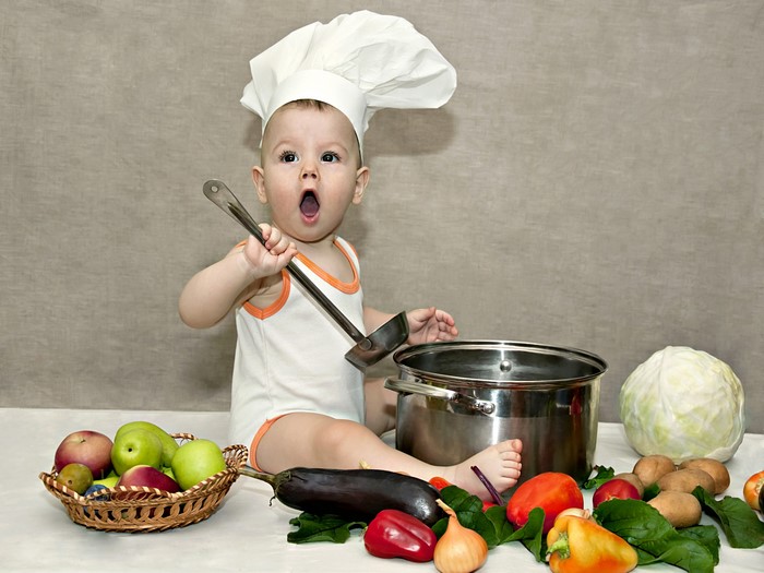 Baby chef with vegetables and fruits