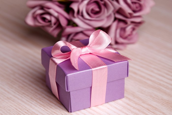 Purple gift box with pink ribbon and roses