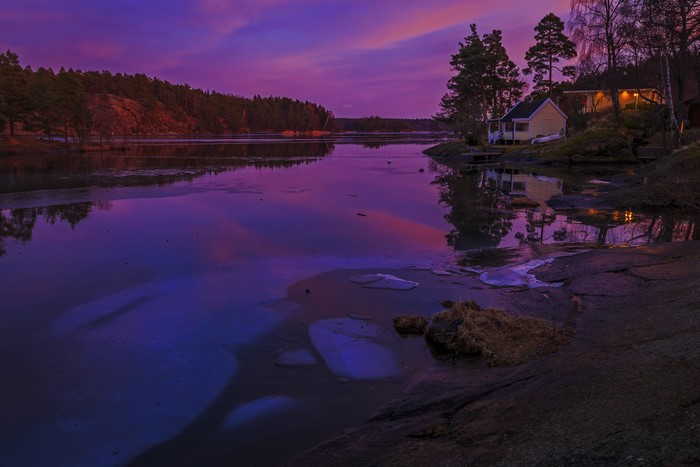 Houses on a rocky shore at dusk