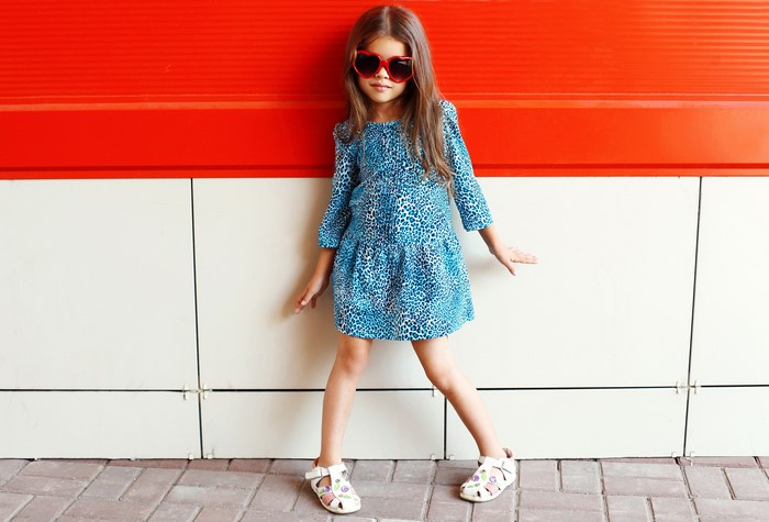 Girl in leopard print dress and heart sunglasses