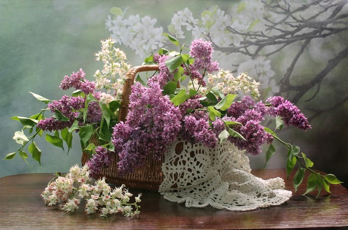 Lilac and white flowers in a wicker basket