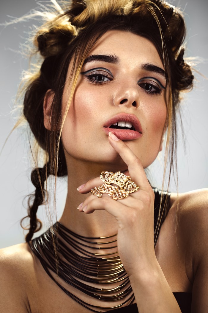 Woman with elaborate hairstyle and jewelry