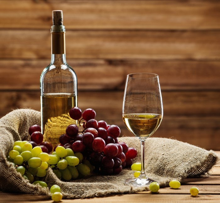 Bottle of White Wine with Grapes and Glass