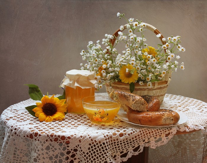 Still life with sunflowers, honey, and bagels
