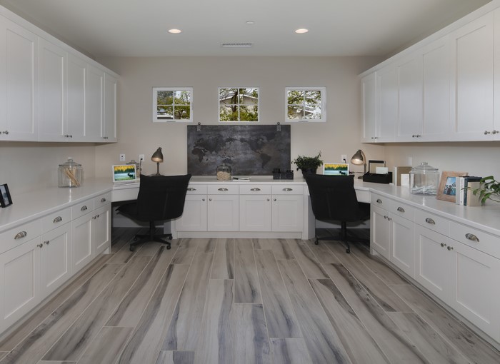 Home office with dual workstations and cabinetry
