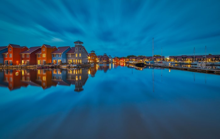 Colorful houses and boats in Groningen, Netherlands at dusk