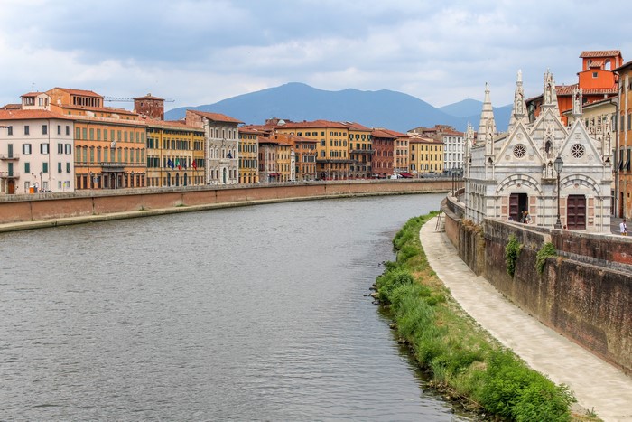 River Arno with buildings and chapel in Pisa, Italy