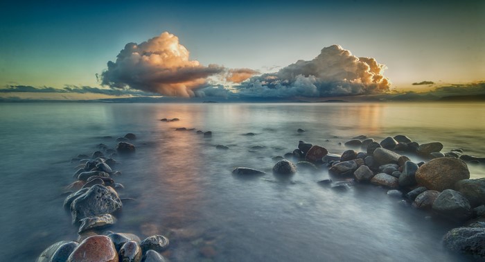 Clouds over the sea with stones in Puerto Rettig
