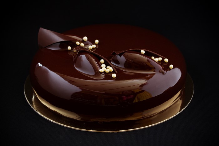 Chocolate cake with white pearls and chocolate decorations