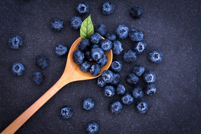 Blueberries on a wooden spoon