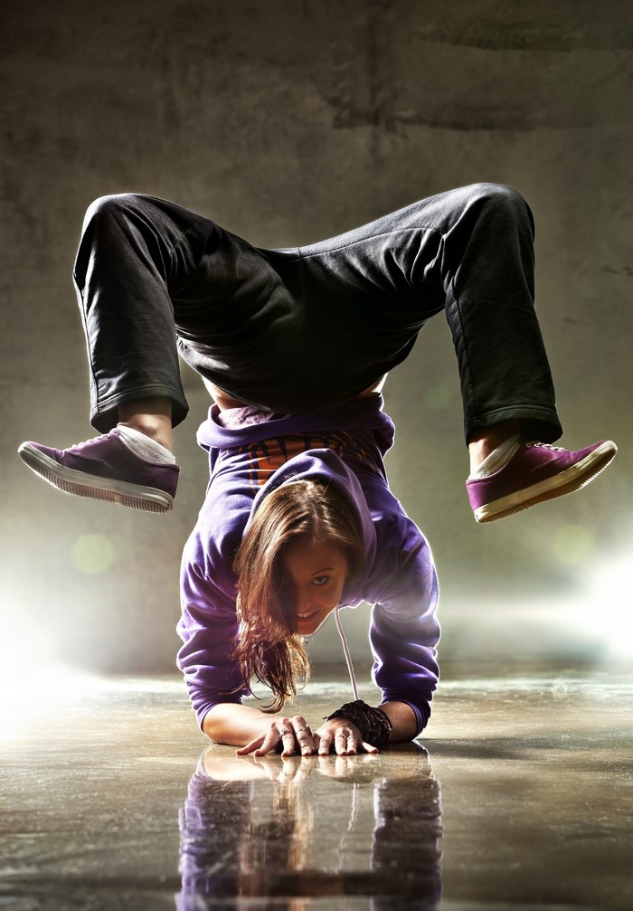Woman breakdancing on hands
