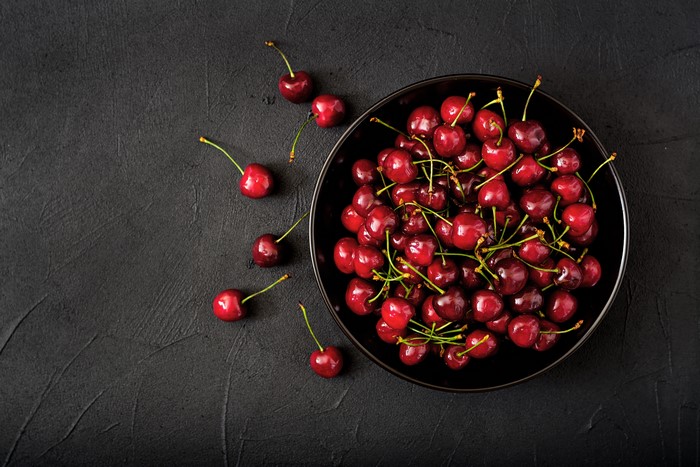 Cherries in a black bowl