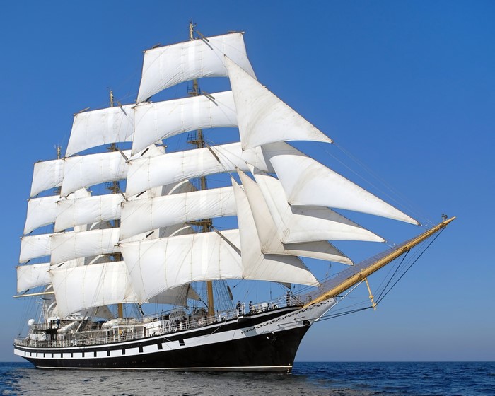 Tall ship with full sails on the ocean