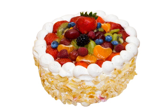 Fruit cake with whipped cream and almonds