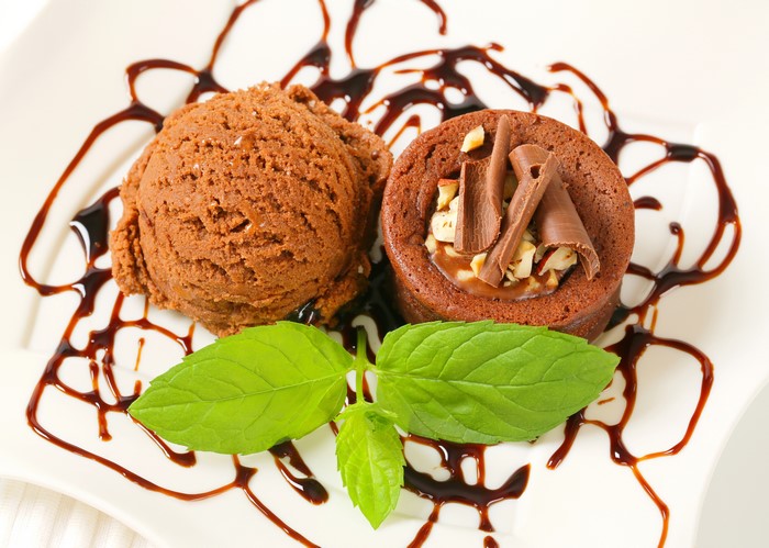 Chocolate ice cream and cupcake with chocolate drizzle