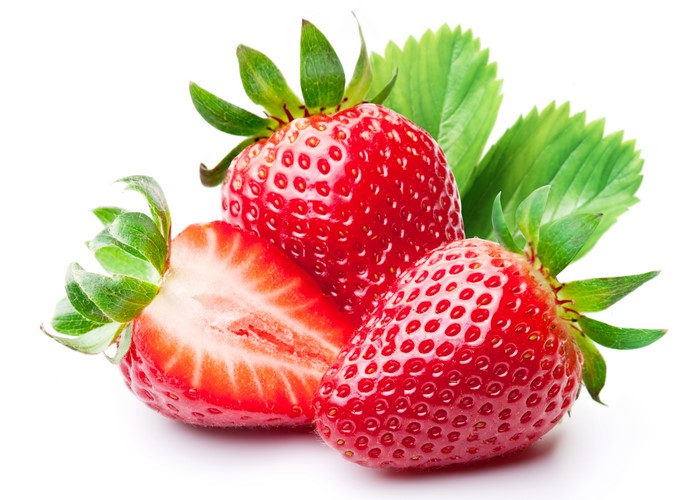 Strawberries with leaves on white background