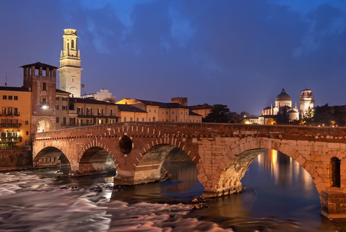 Ponte Pietra bridge over Adige River in Verona at dusk