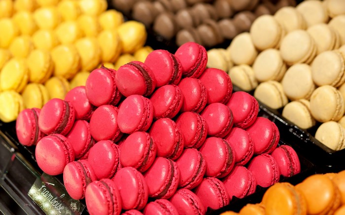 Rows of colorful macarons in a display