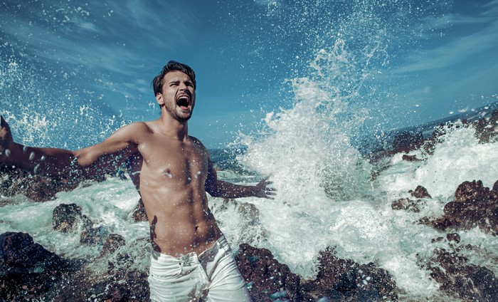 Man screaming in waves and water splash