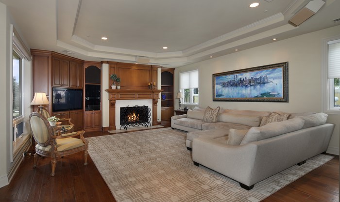Living room with fireplace, sofa, and armchair
