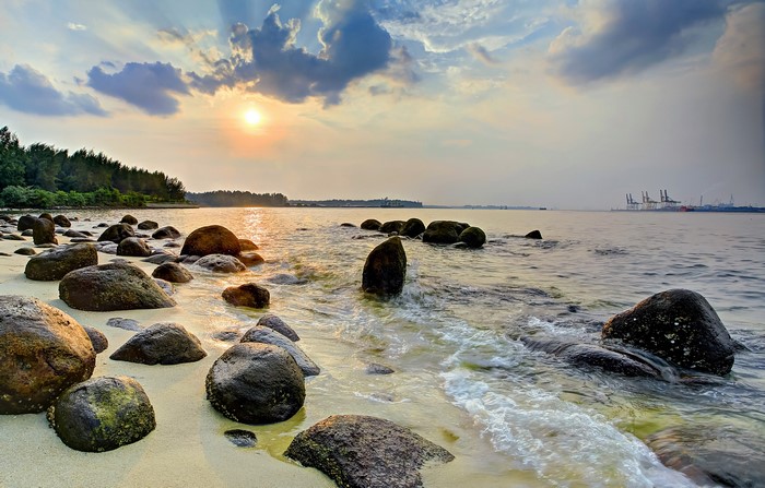 Singapore beach with rocks and sunset