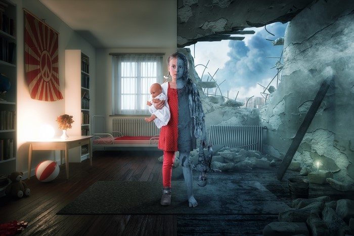 Girl holding doll in ruined room