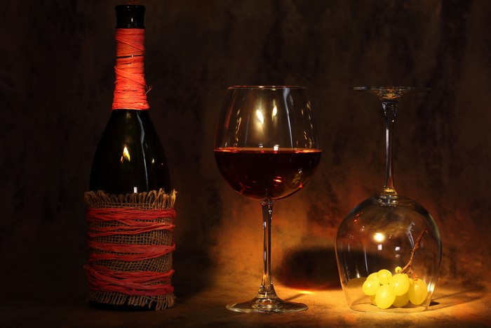 Wine bottle, wine glass, and grapes