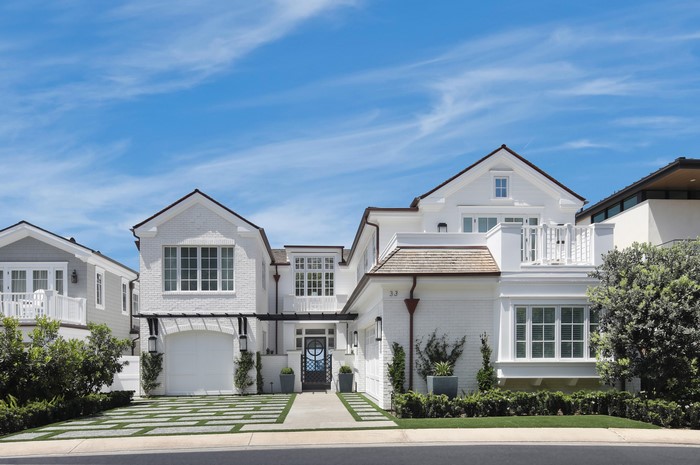 White brick house with garage and blue sky in Dana Point