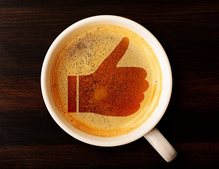Coffee cup with a thumbs up symbol