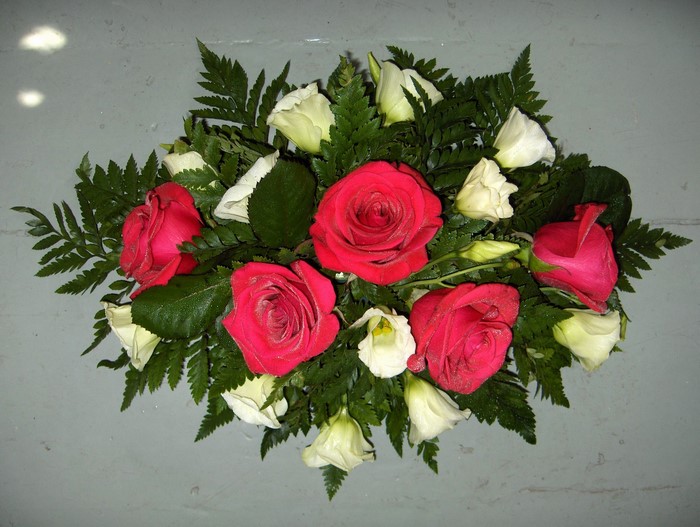Bouquet of red roses and white eustoma flowers with ferns