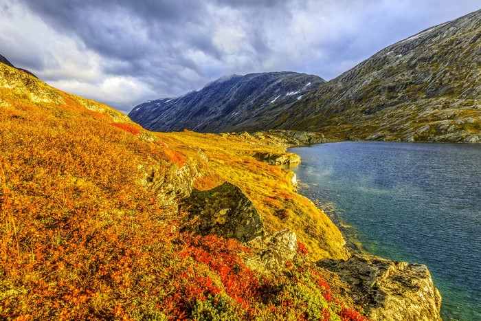 Autumn landscape with lake and mountains in Norway