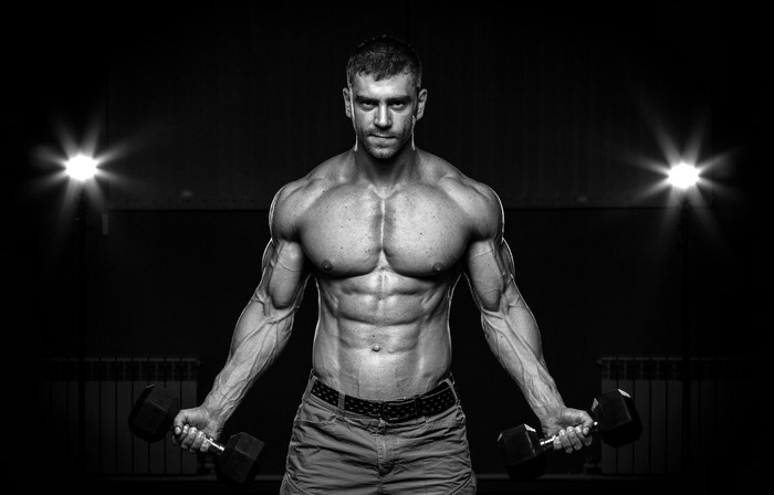 Man with dumbbells in black and white