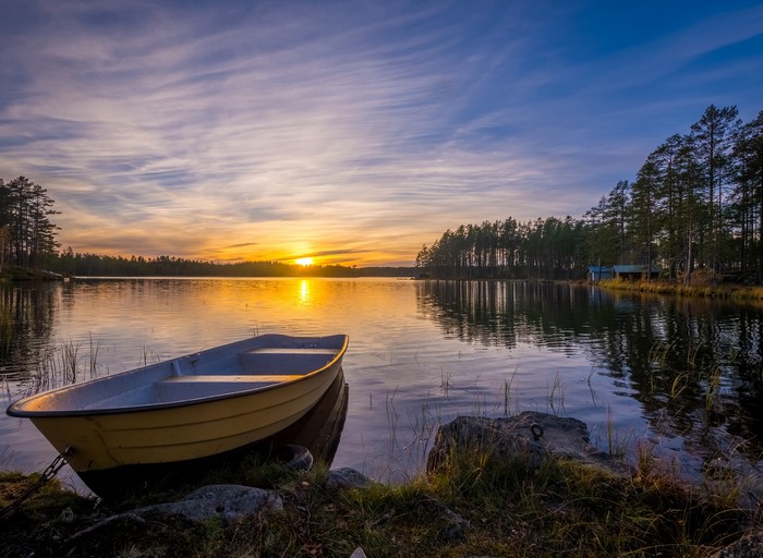 Yellow boat on a lake at sunset in Dalarna, Sweden
