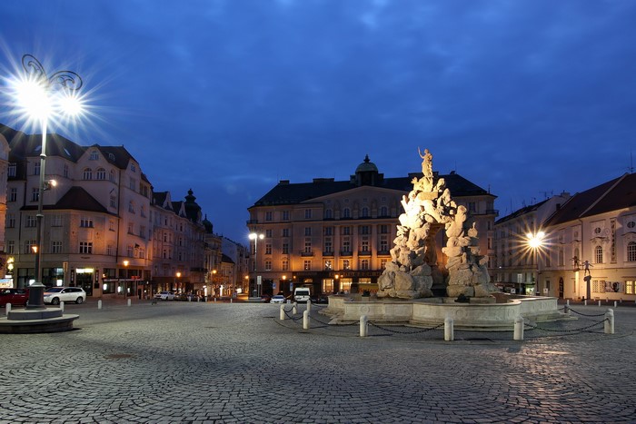 Fountain monument in Brno town square at dusk