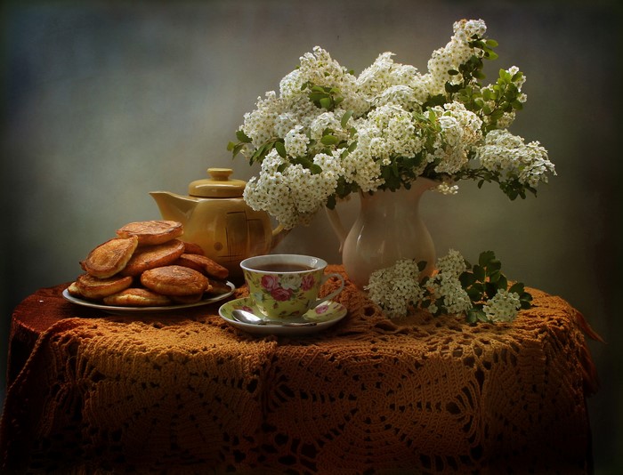 Still-life with pastries, tea, and flowers