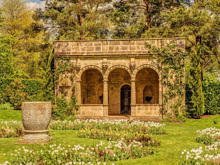 Stone Loggia with Arches and Tulips in a Garden
