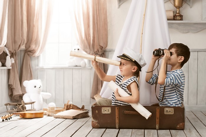 Two Boys in Sailor Uniforms in a Suitcase