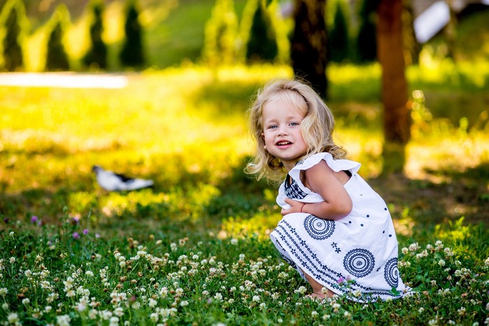 Young girl in a white dress in a grassy field