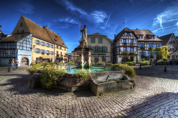 Eguisheim, France Town Square with Fountain and Buildings