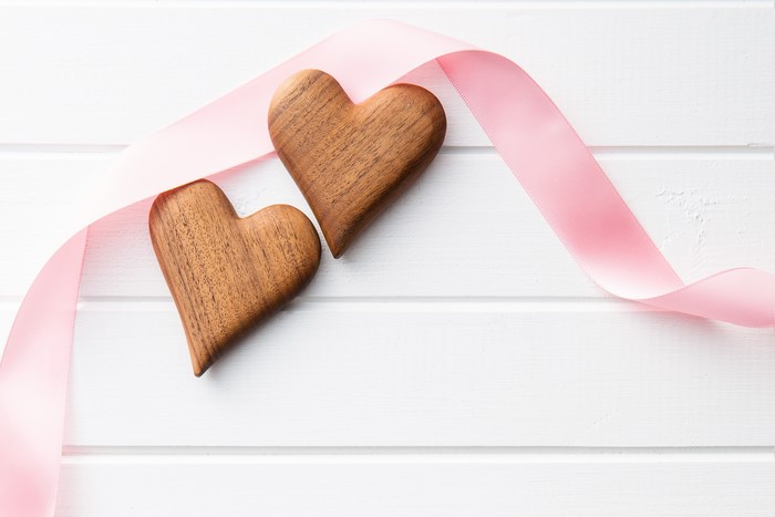 Two wooden hearts with pink ribbon