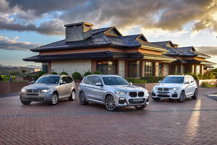 Three BMW X3 cars in front of a house